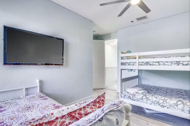 bedroom with wood-type flooring and ceiling fan