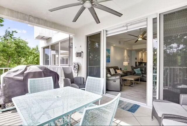 sunroom featuring ceiling fan