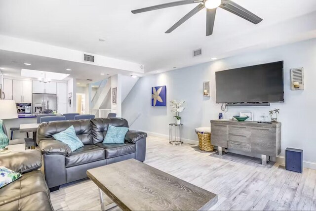 living room with ceiling fan and light hardwood / wood-style floors