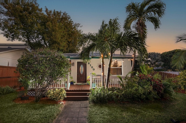 view of front of property with a yard and a deck