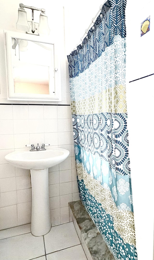 bathroom with tile patterned flooring and tile walls