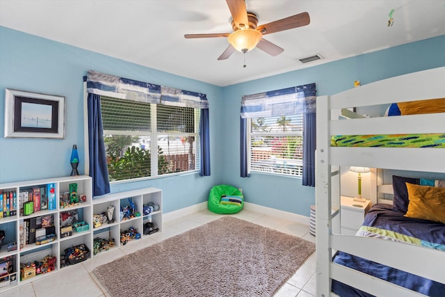 bedroom featuring light tile patterned floors and ceiling fan