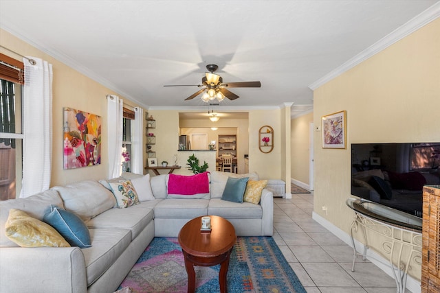 tiled living room featuring crown molding and ceiling fan