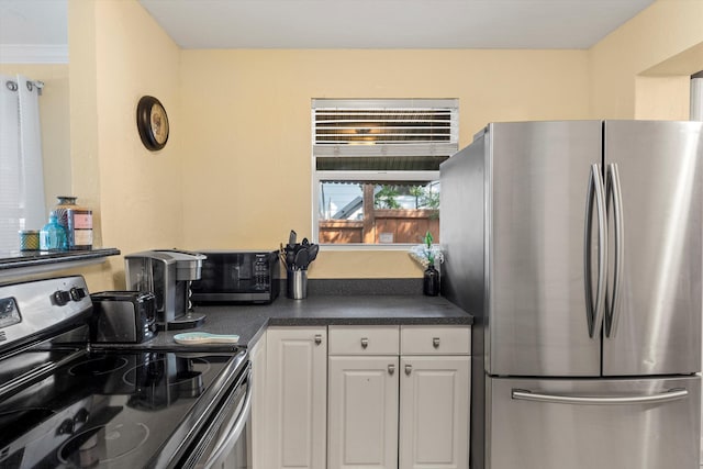 kitchen featuring stainless steel appliances and white cabinets