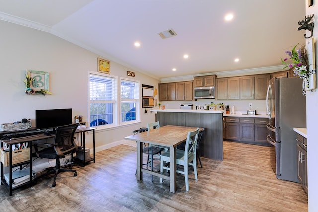 27163 Mariposa Rd, Ramrod, FL 33042 - kitchen with crown molding, light countertops, light wood-style flooring, and appliances with stainless steel finishes