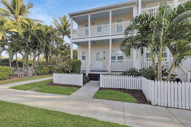 view of front facade with a balcony and covered porch