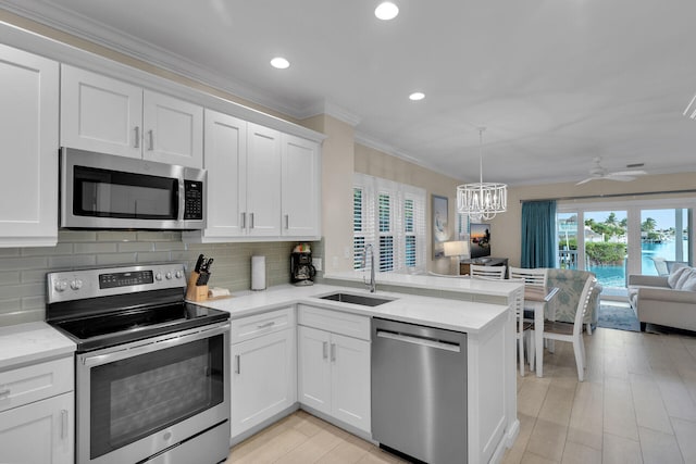 kitchen featuring white cabinetry, appliances with stainless steel finishes, and sink