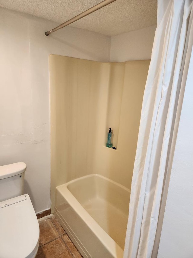 bathroom with toilet and a textured ceiling