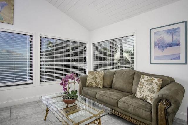 living room featuring vaulted ceiling and light tile patterned flooring