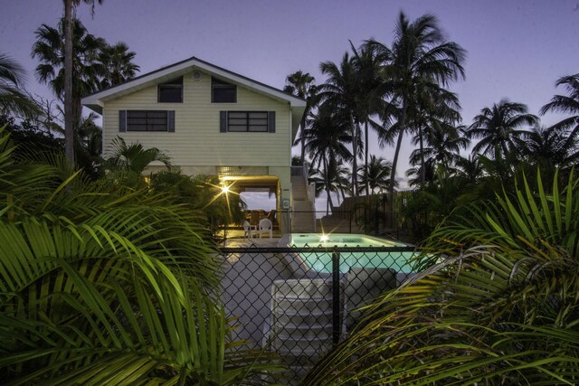 pool at dusk featuring a patio