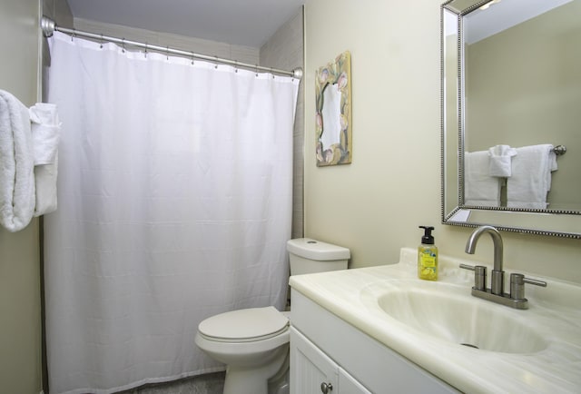 bathroom with vanity, walk in shower, and toilet