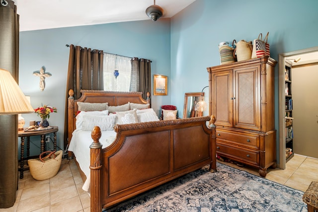 bedroom with vaulted ceiling and light tile patterned floors