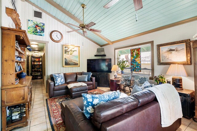 tiled living room with ceiling fan and lofted ceiling