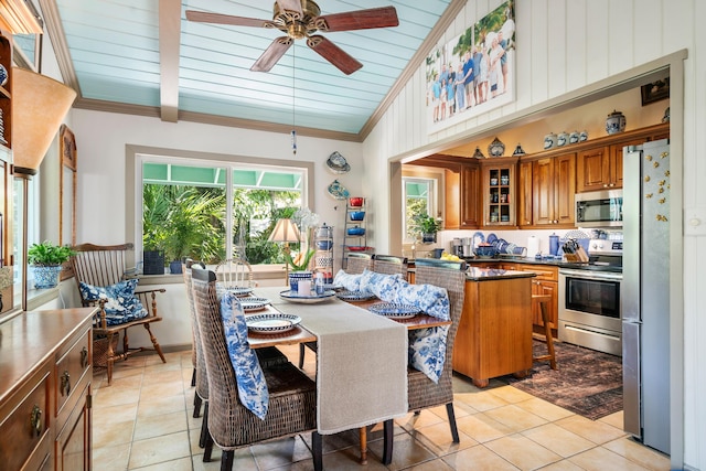 dining area featuring ornamental molding, high vaulted ceiling, light tile patterned floors, and ceiling fan