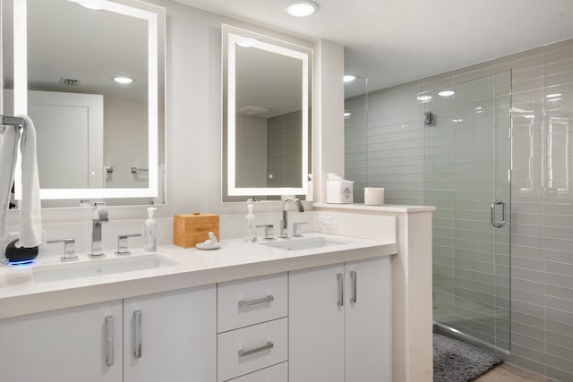 bathroom featuring walk in shower and vanity