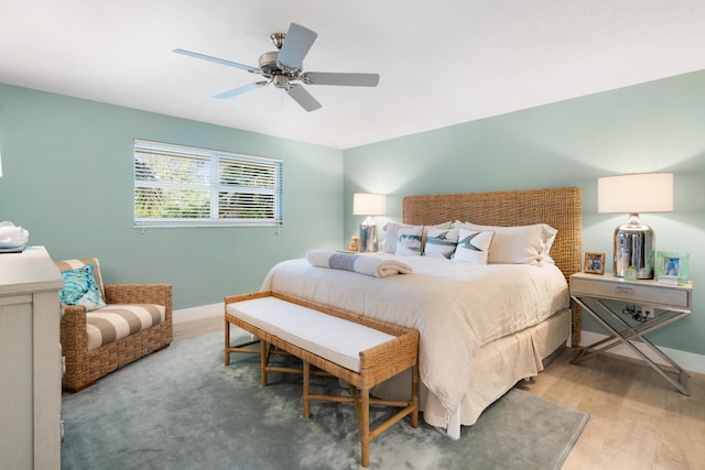 bedroom with ceiling fan and hardwood / wood-style floors