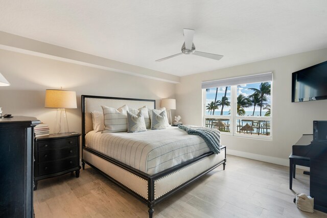 bedroom with ceiling fan and light wood-type flooring