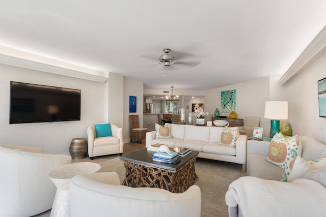 living room featuring ceiling fan with notable chandelier and carpet