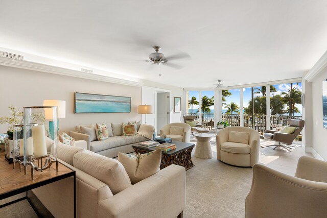 carpeted living room featuring ceiling fan and floor to ceiling windows