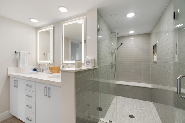 bathroom with vanity and a shower with shower door