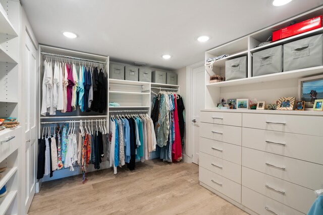 spacious closet with light hardwood / wood-style floors