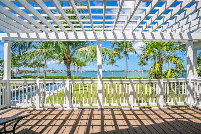 wooden deck featuring a pergola and a water view