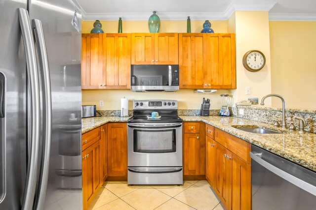 kitchen with a breakfast bar, visible vents, appliances with stainless steel finishes, brown cabinetry, and a peninsula