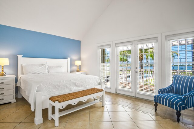 bedroom featuring high vaulted ceiling, light tile patterned flooring, and a ceiling fan