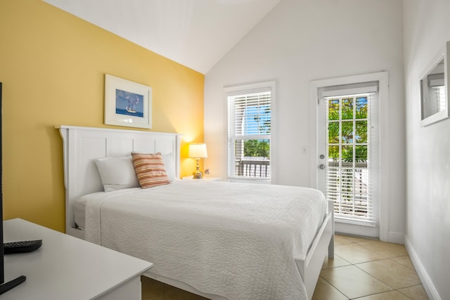bedroom with light tile patterned floors, access to outside, baseboards, and vaulted ceiling