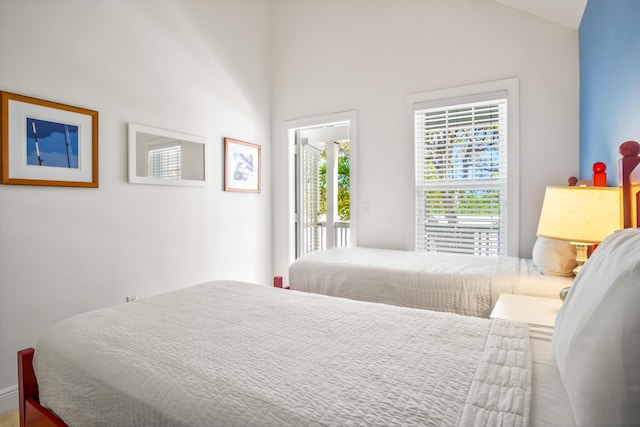 bedroom with access to exterior and lofted ceiling