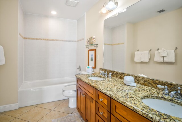 clothes washing area featuring stacked washer and dryer, light tile patterned floors, and laundry area