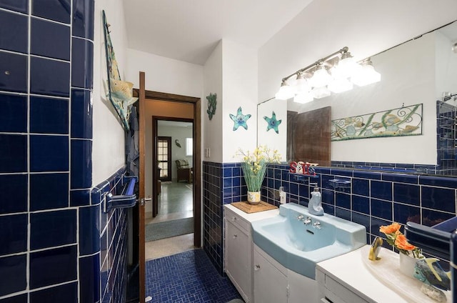 bathroom with vanity and tile walls