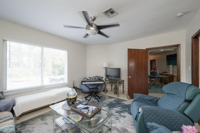 living room featuring ceiling fan and carpet