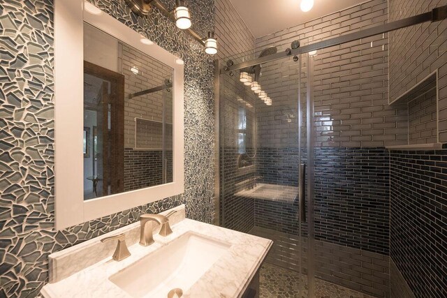 bathroom featuring vanity and an enclosed shower