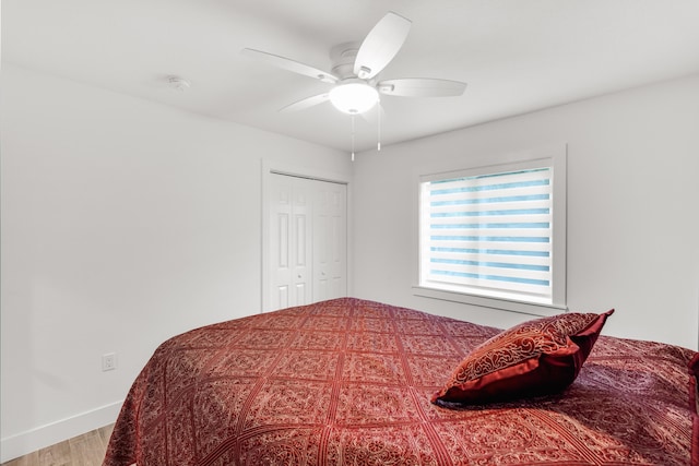 bedroom featuring wood-type flooring, a closet, and ceiling fan