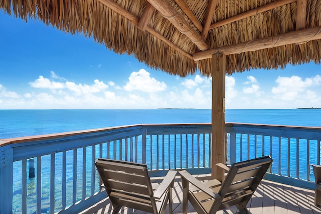 wooden terrace featuring a water view and a gazebo