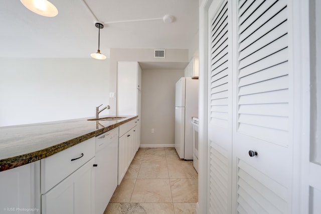 kitchen featuring sink, white appliances, dark stone countertops, white cabinets, and decorative light fixtures