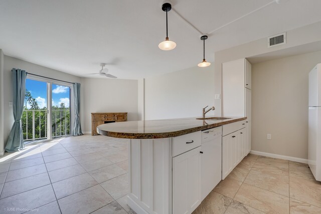 kitchen with white cabinetry, white appliances, kitchen peninsula, and hanging light fixtures