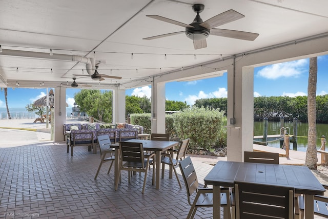 view of patio featuring a water view and a dock