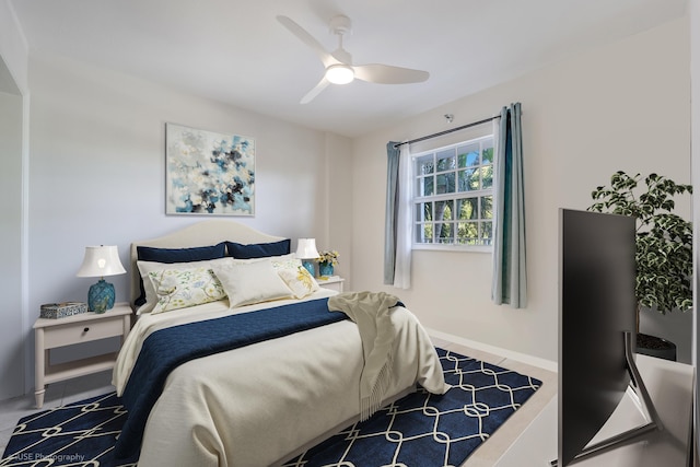 tiled bedroom featuring ceiling fan