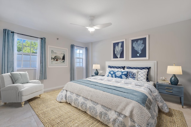 bedroom with ceiling fan and multiple windows