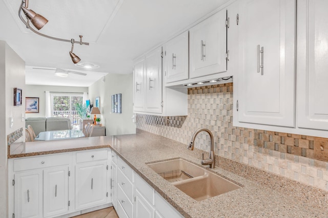 201 E Ocean Dr Unit 110, Key Colony, FL 33051 - kitchen featuring decorative backsplash, white cabinets, and light stone countertops