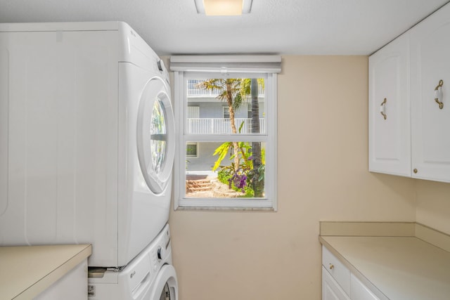 201 E Ocean Dr Unit 110, Key Colony, FL 33051 - washroom featuring cabinet space and stacked washing machine and dryer
