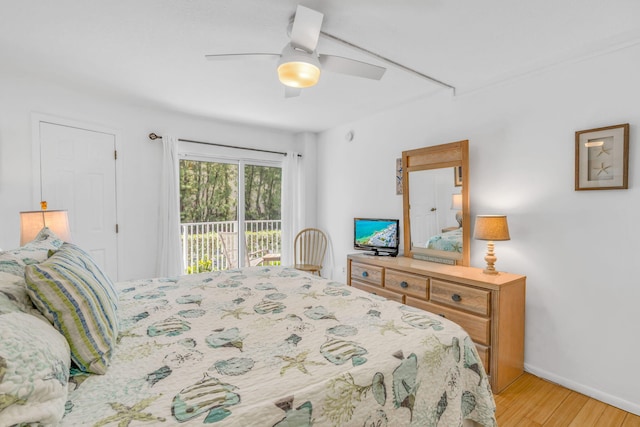 201 E Ocean Dr Unit 110, Key Colony, FL 33051 - bedroom with access to outside, light wood-style flooring, and a ceiling fan