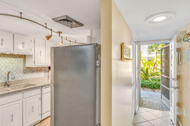 201 E Ocean Dr Unit 110, Key Colony, FL 33051 - kitchen with freestanding refrigerator, light tile patterned floors, and white cabinets