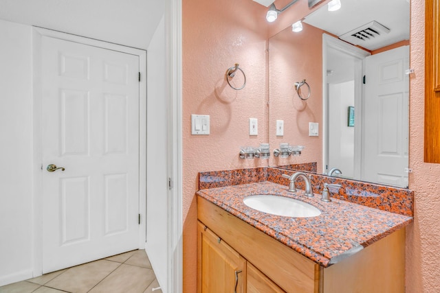 201 E Ocean Dr Unit 110, Key Colony, FL 33051 - bathroom featuring a textured wall, vanity, and tile patterned floors