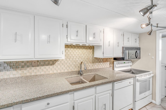 201 E Ocean Dr Unit 110, Key Colony, FL 33051 - kitchen with white appliances, white cabinetry, decorative backsplash, and light stone counters