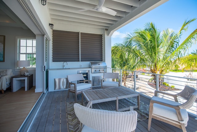 deck featuring area for grilling and sink