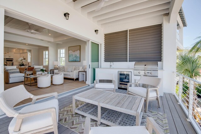 wooden deck with area for grilling, an outdoor living space, and a grill