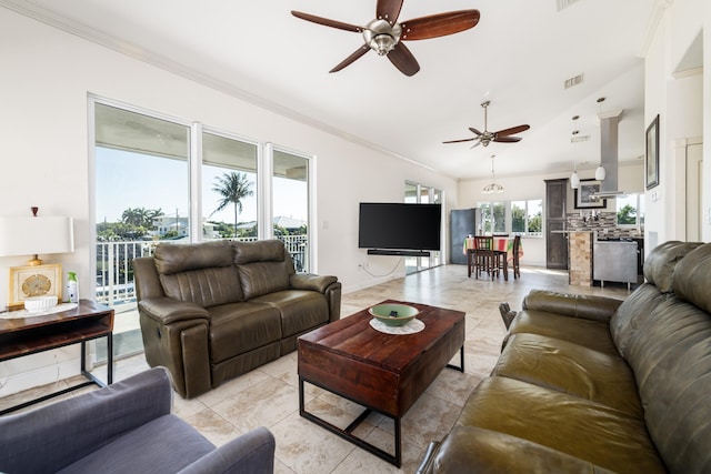 living room featuring crown molding, lofted ceiling, light tile patterned flooring, and ceiling fan